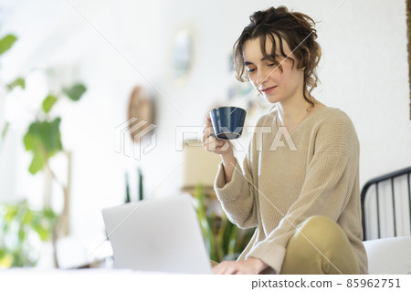 Cute lady playing a computer in the room Cute lady playing a computer in the room 85962751