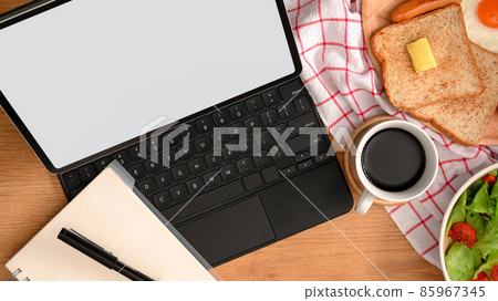 Top view of a modern workspace with digital tablet computer 85967345