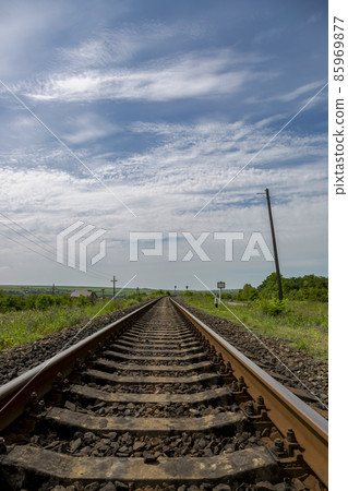 Summer landscape with railroad rails and road 85969877