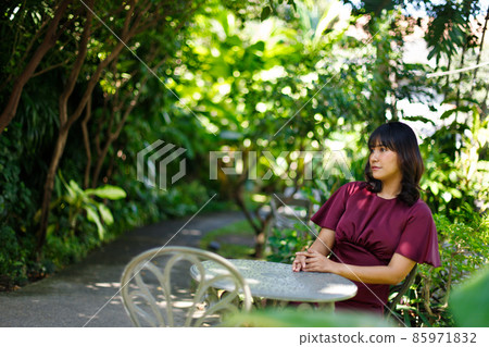 Forest garden in Indian woman purple dress relax style concept. 20s Asian female black short hair Forest garden in Indian woman purple dress relax style concept. 20s Asian female black short hair 85971832