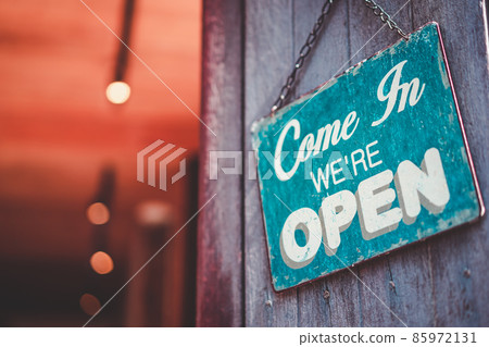 Open sign broad hanging on wood door front of cafe. Business service and food concept.  85972131