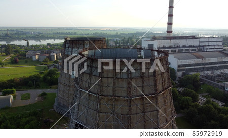 Aerial drone view flight near thermal power plant. Cooling towers of CHP Aerial drone view flight near thermal power plant. Cooling towers of CHP 85972919