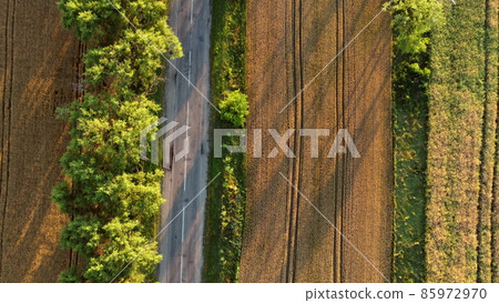 Aerial drone view flight over asphalt road with green trees Aerial drone view flight over asphalt road with green trees 85972970