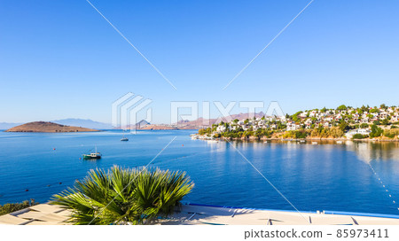 Aegean coast with marvelous blue water, rich nature, islands, mountains and small white houses 85973411