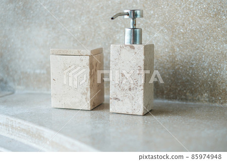 Toiletries bottles in bathroom at luxury hotel or modern home. body shower gel in ceramic ware with wall background 85974948