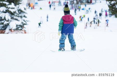 Boys enjoying snowboarding Boys enjoying snowboarding 85976119