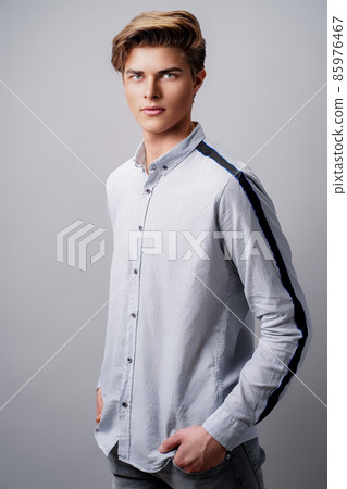 Male hairstyle concept. Handsome man with stylish haircut in stands over white background Male hairstyle concept. Handsome man with stylish haircut in stands over white background 85976467