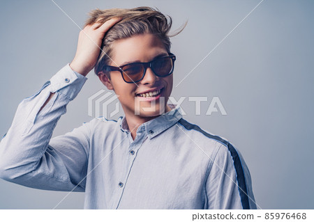 Male hairstyle concept. Portrait of hipster smiling man with stylish haircut in sunglasses. Male hairstyle concept. Portrait of hipster smiling man with stylish haircut in sunglasses. 85976468