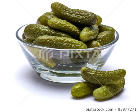 Bowl of Tasty canned Whole green cornichons isolated on a white background 85977271