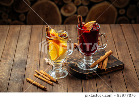 Glass mugs of mulled wine with spices and orange Glass mugs of mulled wine with spices and orange 85977876