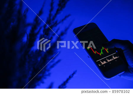 Woman holding mobile phone, block chain with graph of stock market background, cryptocurrencies or bitcoin concept. Night blue light. Futuristic stock exchange Woman holding mobile phone, block chain with graph of stock market background, cryptocurrencies or bitcoin concept. Night blue light. Futuristic stock exchange 85978102