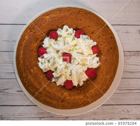 Pastry, Traditional Italian rum cake with whipped cream and raspberries 85978284