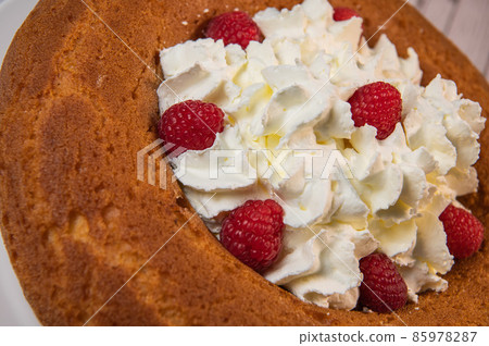 Pastry, Traditional Italian rum cake with whipped cream and raspberries Pastry, Traditional Italian rum cake with whipped cream and raspberries 85978287