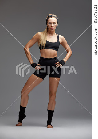 beautiful woman ballet dancer in black swimsuit posing on light grey studio background. Animal instinct beautiful woman ballet dancer in black swimsuit posing on light grey studio background. Animal instinct 85978522