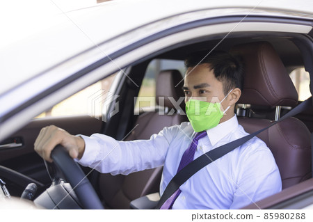 Business man wearing protective mask driving Business man wearing protective mask driving 85980288