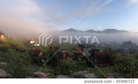 Morning fog dissipates in the mountains Morning fog dissipates in the mountains 85980727