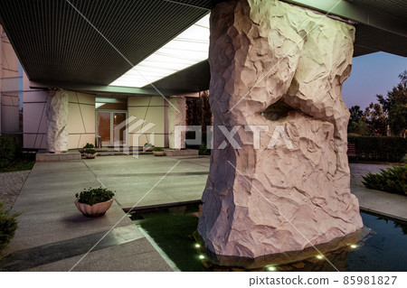 Roofed porch of country house with lighting and stone columns 85981827