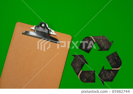 Paper recycling concept on green background top view Paper recycling concept on green background top view 85982744