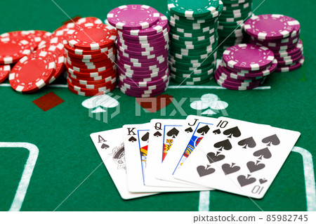 Playing cards and chips on green casino table background Playing cards and chips on green casino table background 85982745