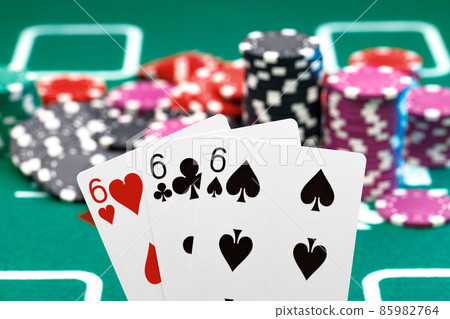 Playing cards and chips on green casino table background Playing cards and chips on green casino table background 85982764