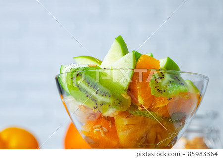 Sliced fresh fruits in a glass bowl Sliced fresh fruits in a glass bowl 85983364
