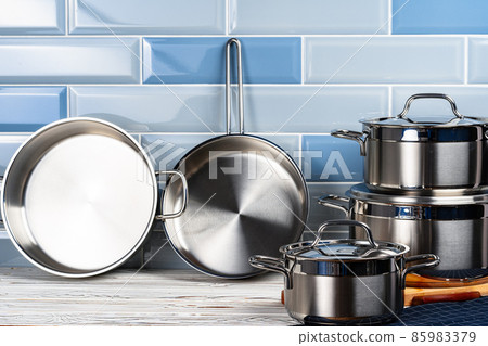 Set of aluminum cookware on kitchen counter 85983379