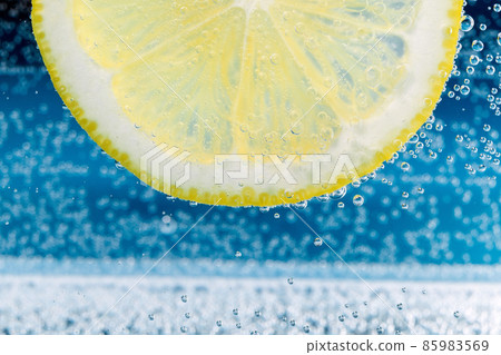 Lemon close-up. Slice of lemon, mineral bubbles. lemonade Lemon close-up. Slice of lemon, mineral bubbles. lemonade 85983569