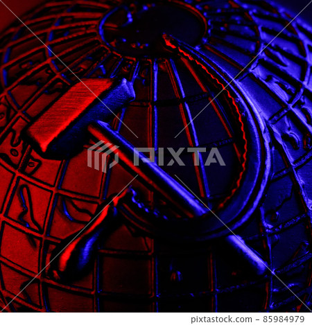 Metal coat of arms of USSR with hammer and sickle on background of globe of earth. Symbol of 85984979