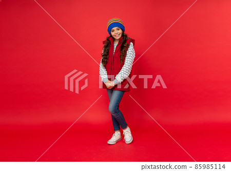 full length of child wearing warm clothes. express positive emotion. winter fashion. 85985114