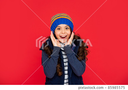portrait of child wearing warm clothes. express positive emotion. winter fashion. 85985575