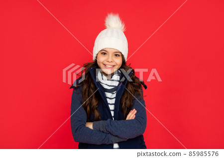 teen girl on red background. portrait of child wearing warm clothes. express positive emotion. 85985576