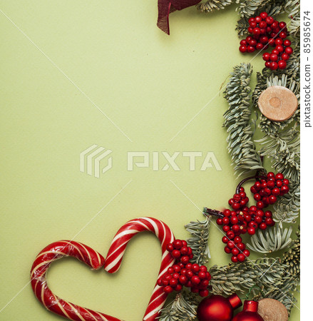 christmass stuff laying flat on colorful background, branch of tree, balls, candy 85985674