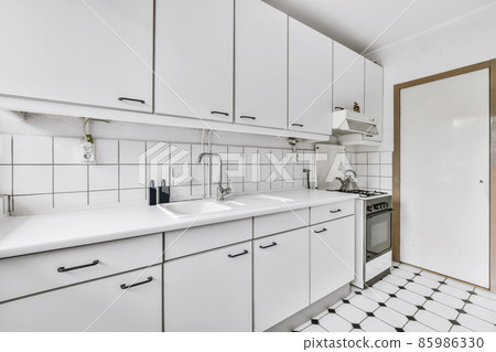 Beautiful kitchen area with hanging cabinet and glass oven Beautiful kitchen area with hanging cabinet and glass oven 85986330
