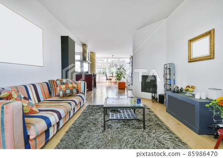 Attractive living room with a bright sofa and soft carpet Attractive living room with a bright sofa and soft carpet 85986470