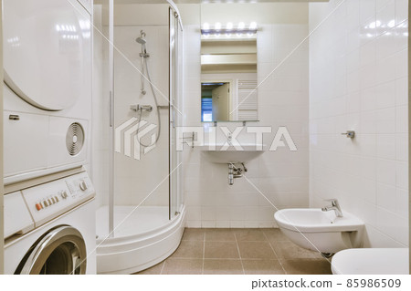 Attractive bathroom with washing machine and shower 85986509