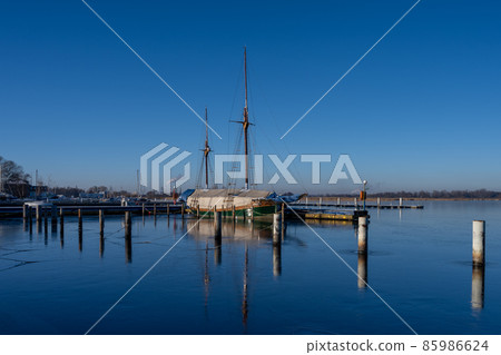 A sailboat in a marina closed down for winter 85986624