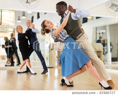 Two professional dancers practicing lindy hop in dance class Two professional dancers practicing lindy hop in dance class 85986727