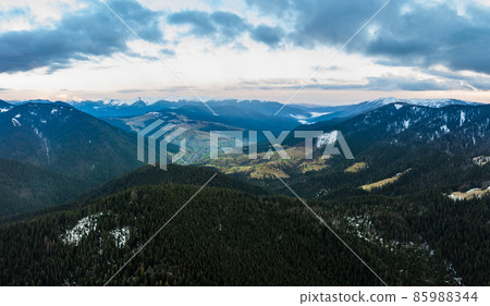 Carpathian village between the mountain tops, dawn in the mountains, panorama of the village in the mountains. 85988344