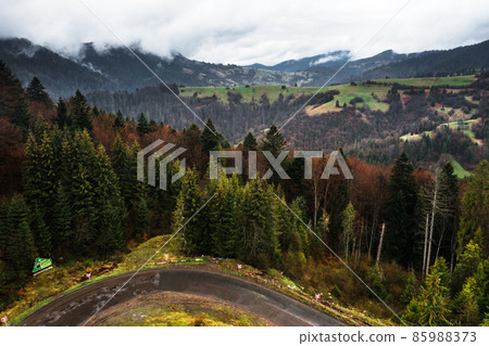 Ukrainian roads in the mountains, serpentines from roads and forests, views of the mountains and the road. Ukrainian roads in the mountains, serpentines from roads and forests, views of the mountains and the road. 85988373