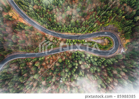 Serpentine roads in Ukraine, fog in the mountains, serpentine road in the fog, drove on top of the road. 85988385