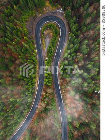 Serpentine roads in Ukraine, fog in the mountains, serpentine road in the fog, drove on top of the road. 85988386