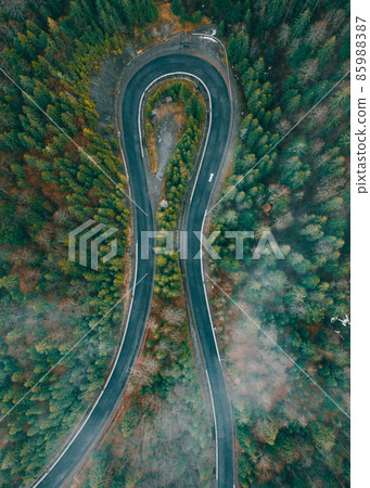 Serpentine roads in Ukraine, fog in the mountains, serpentine road in the fog, drove on top of the road. 85988387