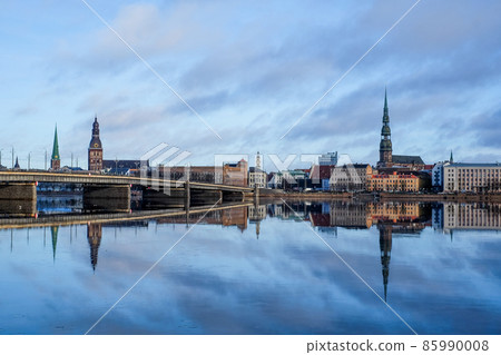 Beautiful panorama of Riga center over Daugava river with St Peters Church and Stone bridge in winter. Selective focus 85990008