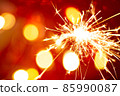 Sparkler on bokeh red background 85990087