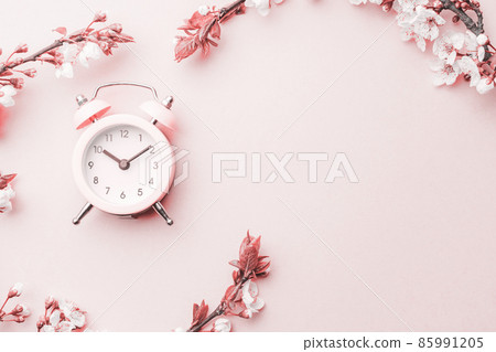 Spring border, spring blossom and April floral nature with alarm clock on pink background. Branches of blossoming apricot macro soft focus. Easter and spring greeting cards, copy space. Springtime. Spring border, spring blossom and April floral nature with alarm clock on pink background. Branches of blossoming apricot macro soft focus. Easter and spring greeting cards, copy space. Springtime. 85991205