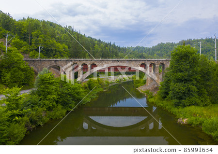 Nikolsky stone bridge over the Sim river in the Chelyabinsk region of Russia. The author of the project Belelyubsky. Aerial photo 85991634