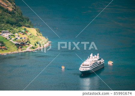 Geirangerfjord, Norway. Touristic Ship Ferry Boat Floating Liner Moored Near Geiranger In Geirangerfjorden In Spring Summer Day. Famous Norwegian Landmark And Popular Destination 85991674