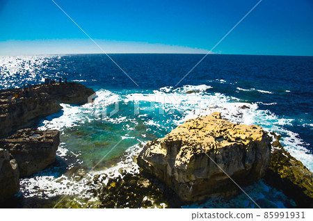 Watercolor drawing of Rocky coastline and sea near collapsed Azure window in Dwejra Bay 85991931