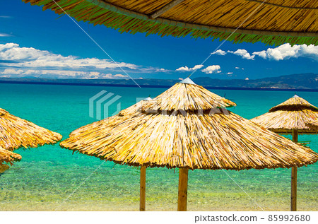 Watercolor drawing of View of blue azure paradise water of Toroneos kolpos gulf, blue sky white clouds over Sithonia peninsula 85992680