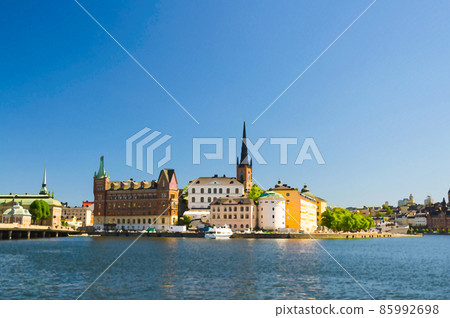 Watercolor drawing of Riddarholmen island district with Riddarholm Church spires and typical sweden colorful gothic buildings Watercolor drawing of Riddarholmen island district with Riddarholm Church spires and typical sweden colorful gothic buildings 85992698